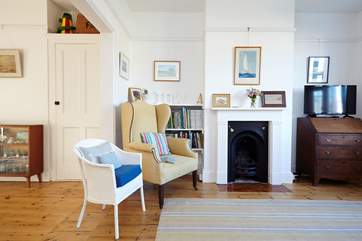 The main living room has an original ornamental fireplace, bringing charm and character to the room