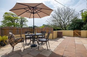 There is a spacious enclosed patio to the front and side of Nanteague Cottage, with a built-in barbecue.