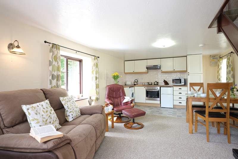 The open plan living-room is very comfortable with a reclining sofa and easy chair.