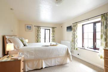 Two big windows make the bedroom light and bright.
