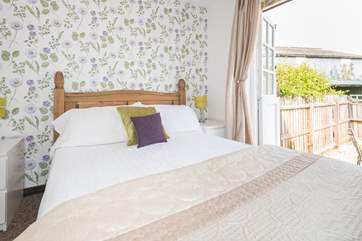 The master bedroom with doors that open onto the decking.