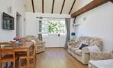 Vaulted ceiling with wood beams gives the cottage a light airy feel. - Thumbnail Image