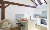 The modern kitchen has vaulted ceilings with skylights and wooden beams giving a lovely cottage feel throughout. - Thumbnail Image