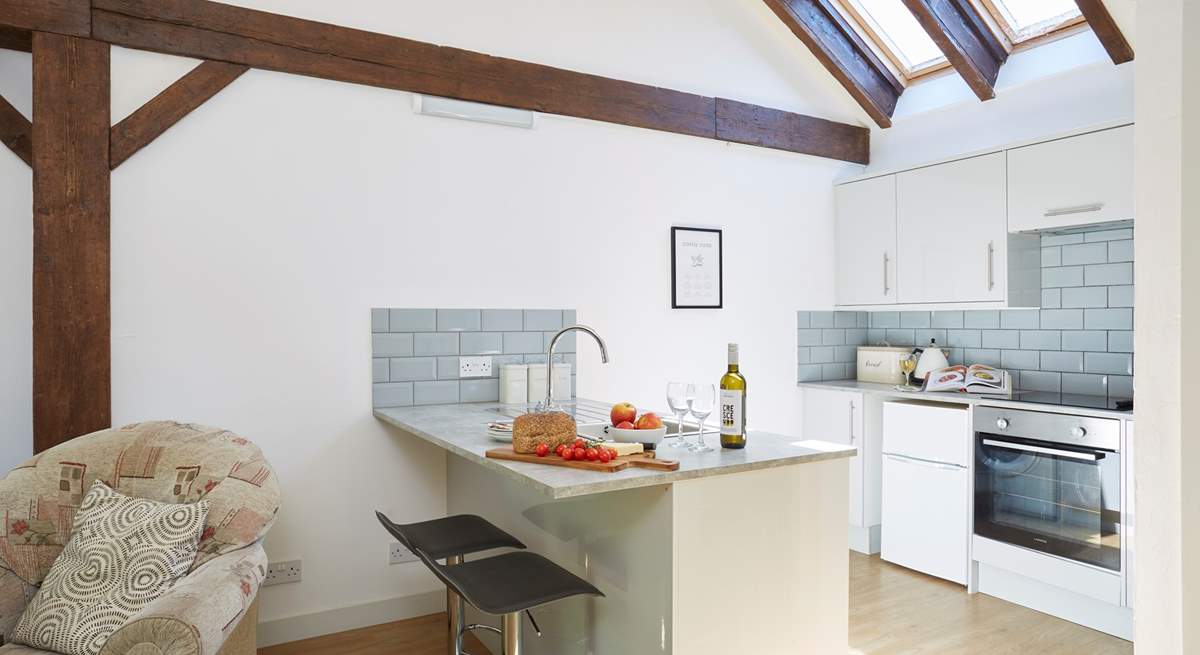 The modern kitchen has vaulted ceilings with skylights and wooden beams giving a lovely cottage feel throughout.