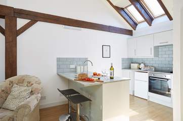 The modern kitchen has vaulted ceilings with skylights and wooden beams giving a lovely cottage feel throughout.