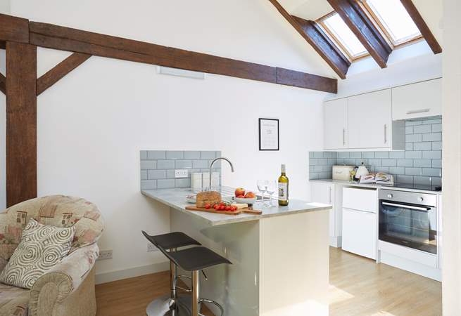The modern kitchen has vaulted ceilings with skylights and wooden beams giving a lovely cottage feel throughout.