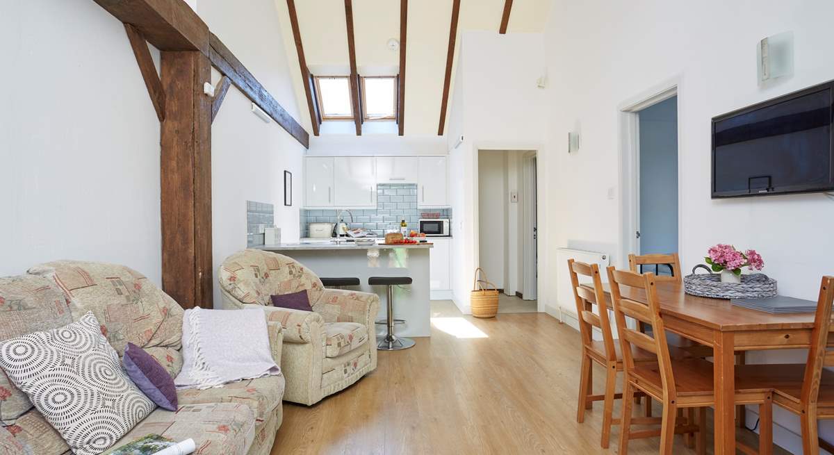 A light and airy open plan living-area with exposed beams.