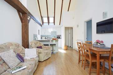 A light and airy open plan living-area with exposed beams.