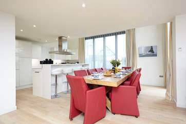 The gorgeous open plan kitchen and dining area has double-height bi-folding doors leading out on to the external decking, with panoramic Solent views.