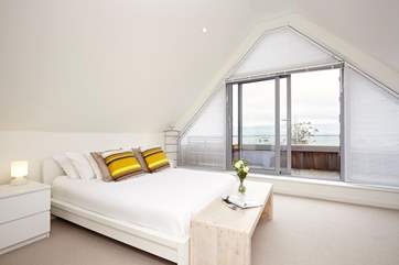 The main bedroom with doors opening out to the balcony with seating to enjoy the fabulous view.