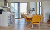 The gorgeous open plan kitchen and dining area has double-height bi-folding doors leading out on to the external decking, with panoramic Solent views. - Thumbnail Image