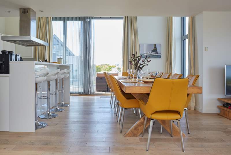 The gorgeous open plan kitchen and dining area has double-height bi-folding doors leading out on to the external decking, with panoramic Solent views.