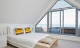 Bedroom 5 has doors opening out to the balcony, with seating to enjoy the fabulous view. - Thumbnail Image