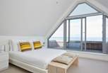 The main bedroom has doors opening out to the balcony with seating to enjoy the fabulous view.