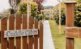 Welcome to Cuddle Cabin at the end of the tree-lined gravel path. - Thumbnail Image