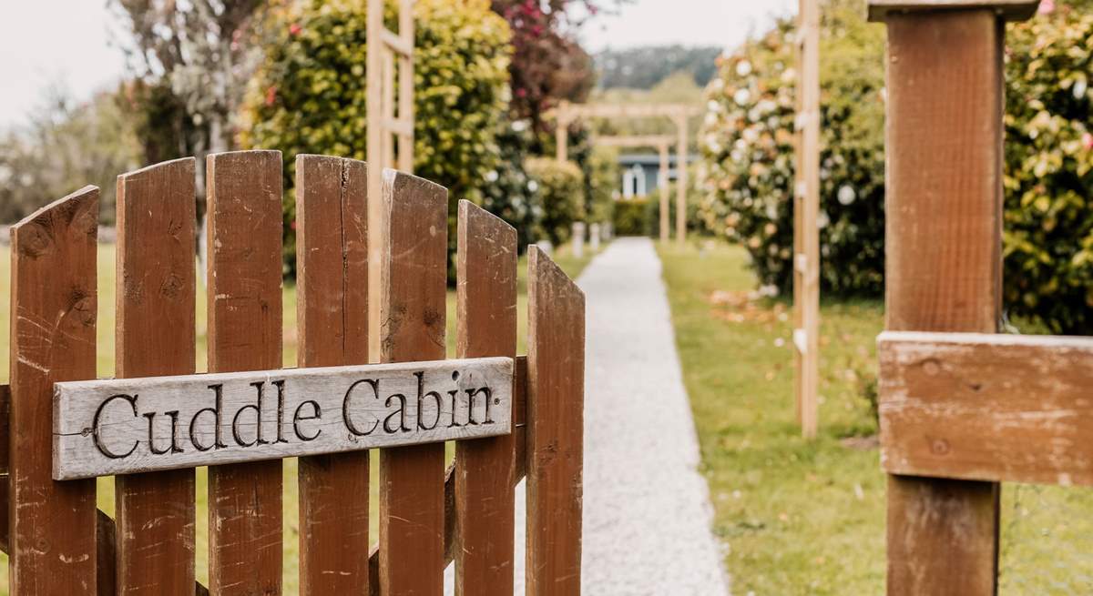 Welcome to Cuddle Cabin at the end of the tree-lined gravel path.