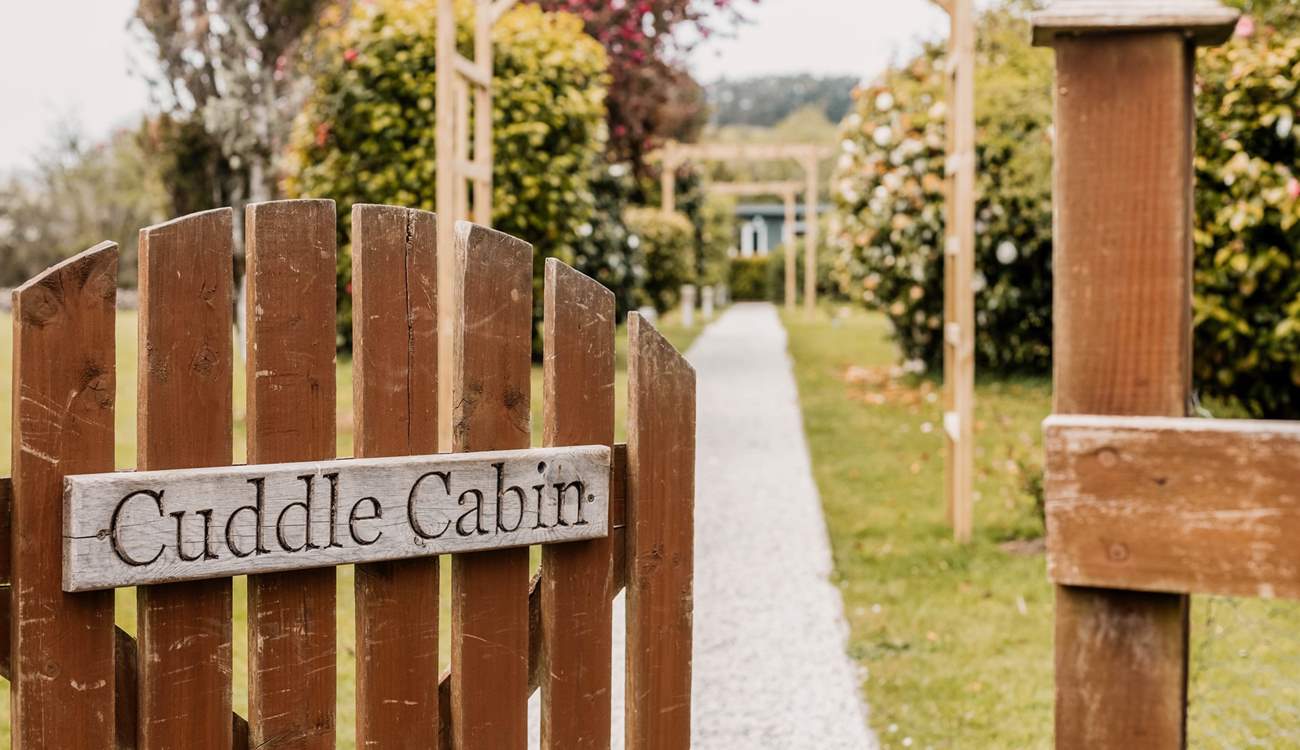 Welcome to Cuddle Cabin at the end of the tree-lined gravel path.