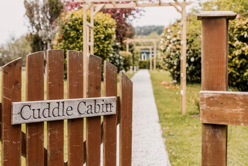 Welcome to Cuddle Cabin at the end of the tree-lined gravel path.