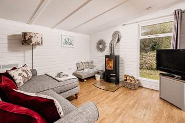 The comfy sofa is the perfect place to relax in front of the wood-burner.