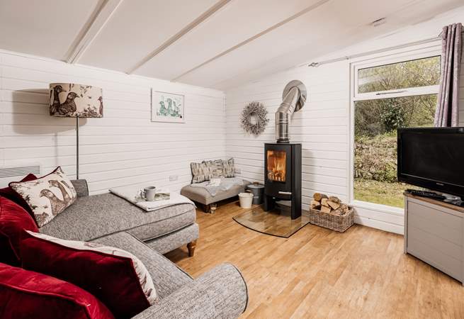 The comfy sofa is the perfect place to relax in front of the wood-burner.