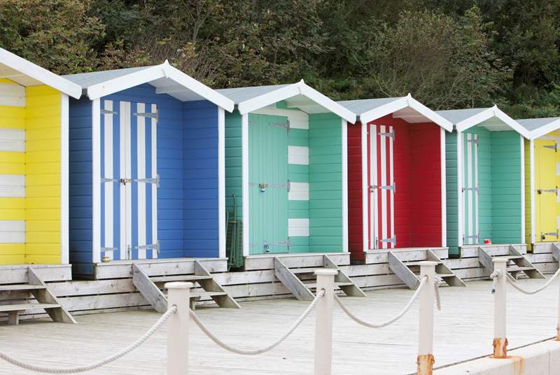 Why not hire a colourful beach hut?