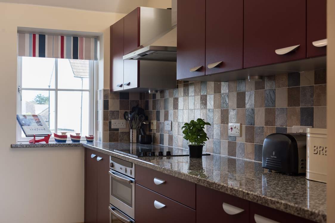 The kitchen is open to the sitting and dining-areas.