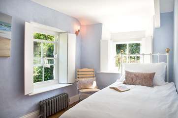 The single bedroom, decorated in pretty pastel shades.