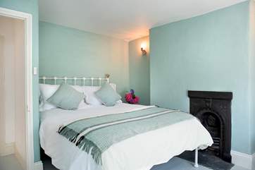 The second double bedroom also has a king-size bed and a delightful ornamental fireplace.