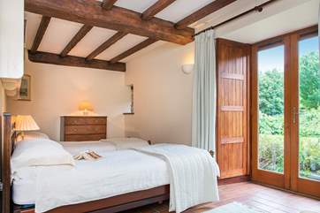 Double doors lead out from the twin bedroom to the garden.