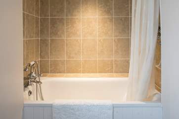 The family bathroom has a shower over the bath, and a hand held shower.