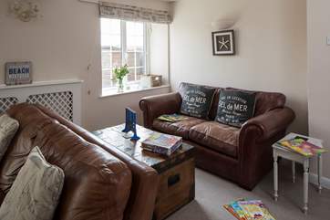Two large sofas fill this end of the sitting-room, plently of space for reading and games.