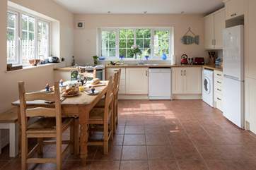 The spacious kitchen is very well-equipped, the window looks out towards Langdon Woods.