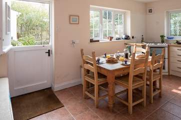 The kitchen looks out over the rear patio, facing south west. Two steps lead down to the dining-room.