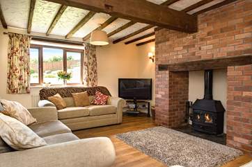 The cosy sitting-room has plenty of space for all to relax and unwind and the toasty wood-burner is a welcome sight on those winter escapes.