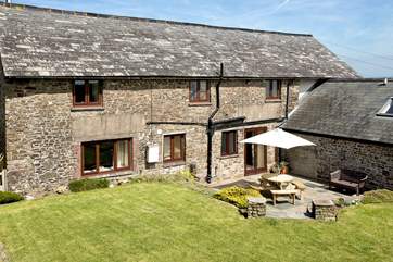 At the back there is a large garden and a suntrap of a terrace area to enjoy alfresco dining from sun rise to sunset