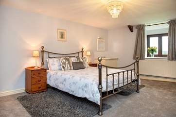Wonderfully spacious bedroom 1 has a kingsize bed with a gorgeous bedstead and a handy vanity unit