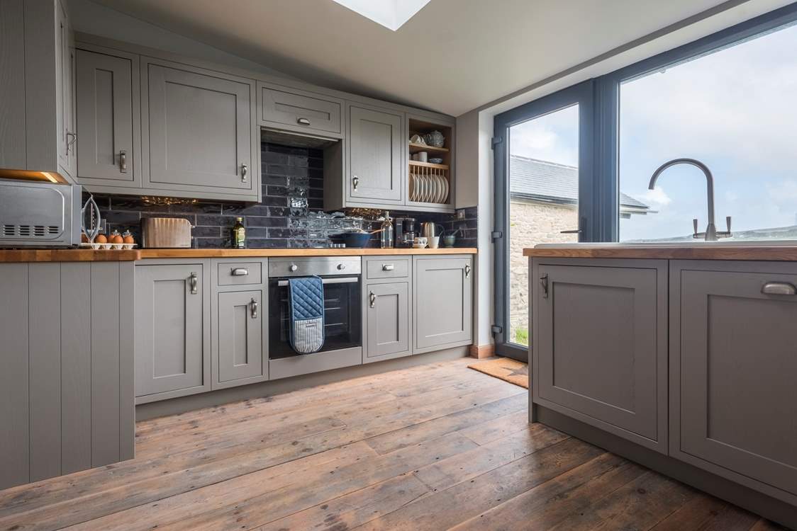 The kitchen gives access to the enclosed lawned garden.