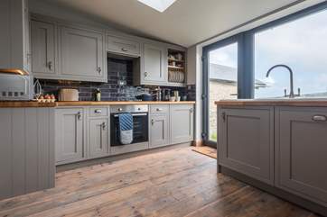 The kitchen gives access to the enclosed lawned garden.