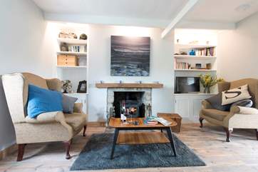 The sitting-room is cosy and warmed by a wood-burner.