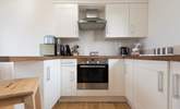 The kitchen is complete with an induction hob, and is compact, light and airy. - Thumbnail Image