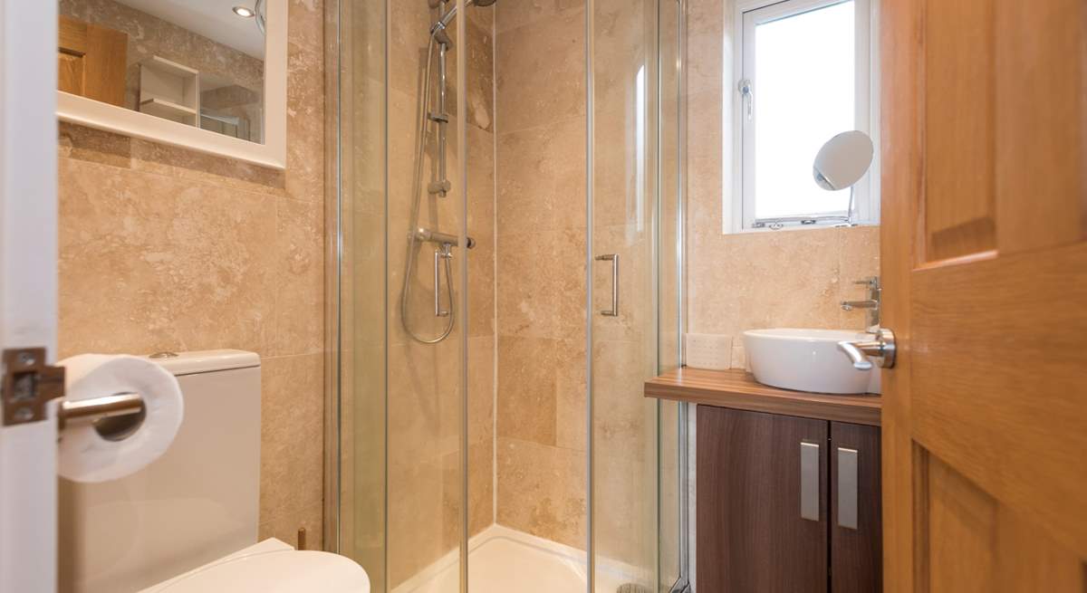 Enjoy a shower in the compact shower-room after a day on the nearby beach.