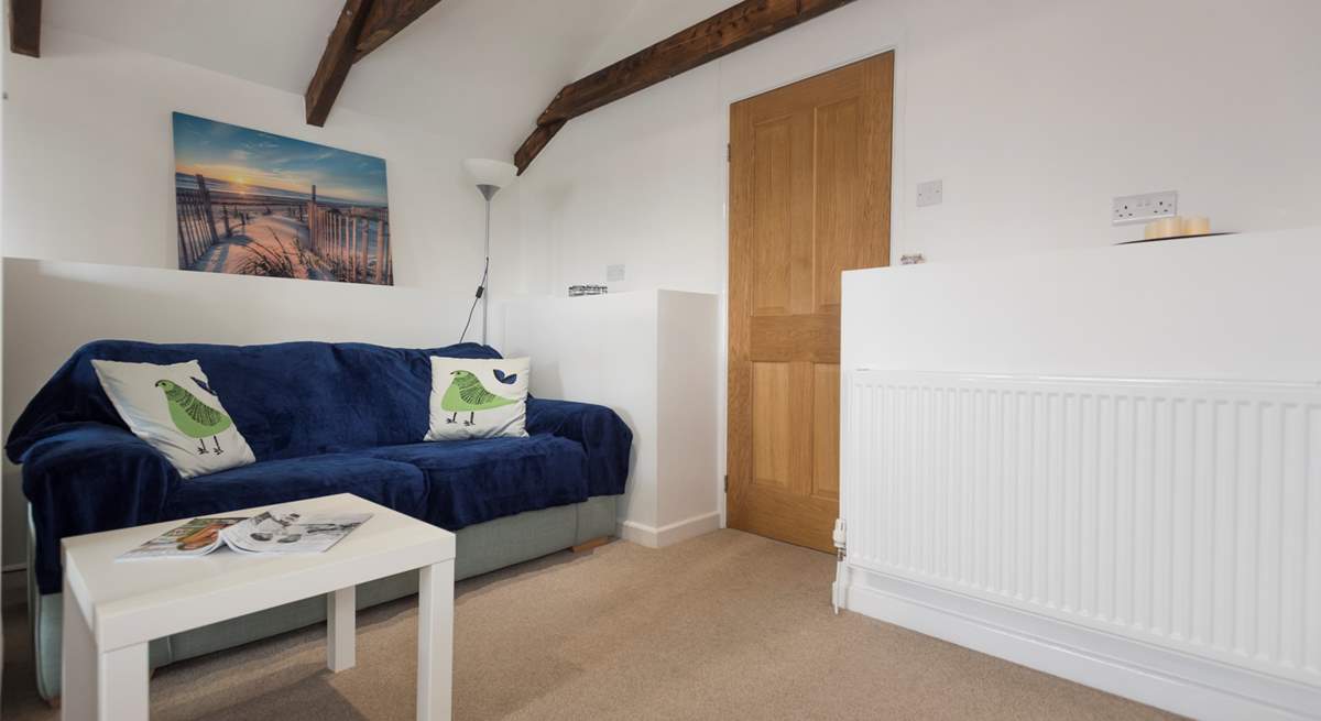 The door from the sitting and bedroom area opens onto three steps down to the shower-room and kitchen/dining-room.