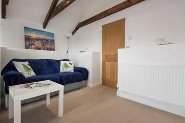 The door from the sitting and bedroom area opens onto three steps down to the shower-room and kitchen/dining-room.