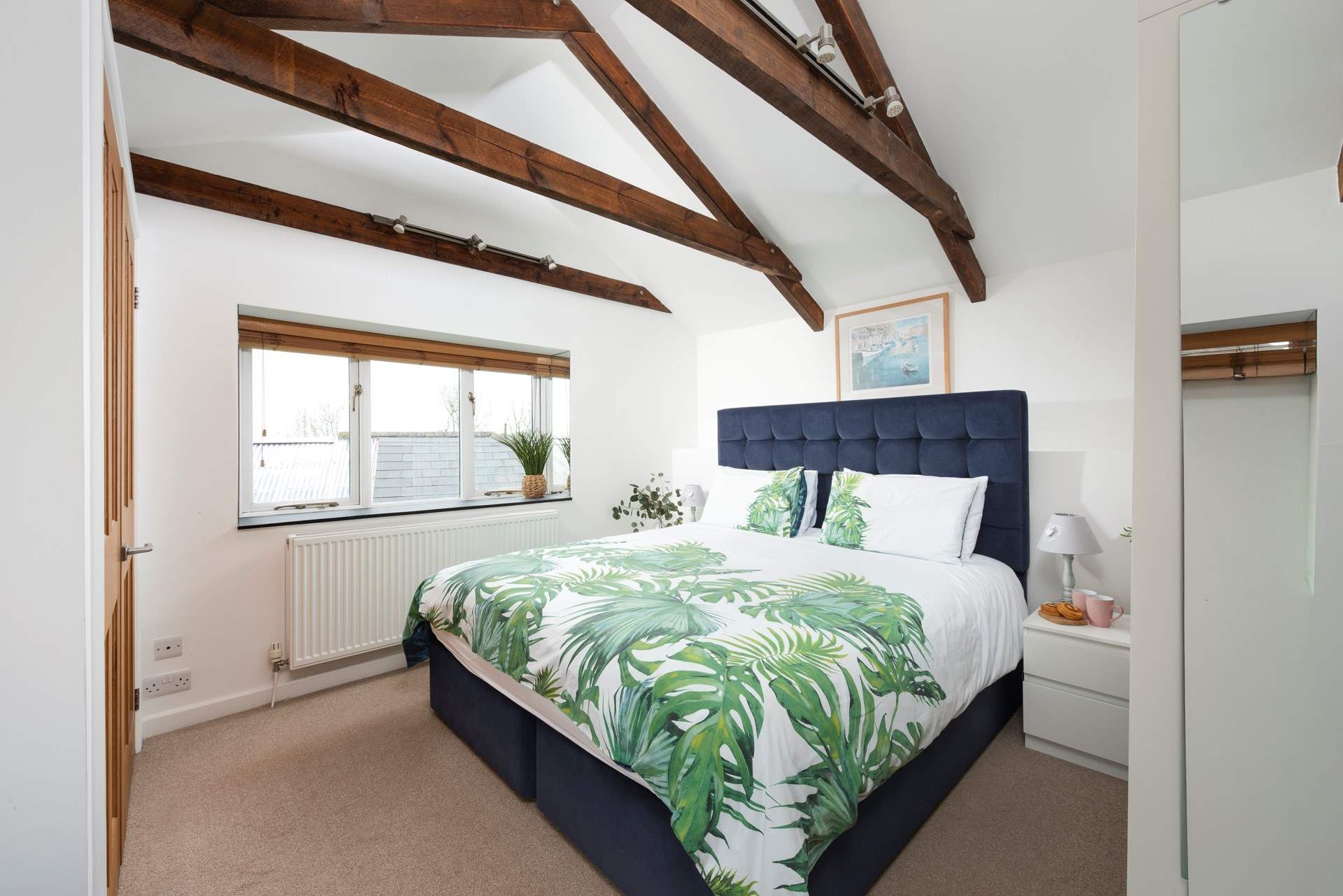 A room filled with natural light and views of the Cornish countryside.