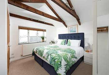 A room filled with natural light and views of the Cornish countryside.