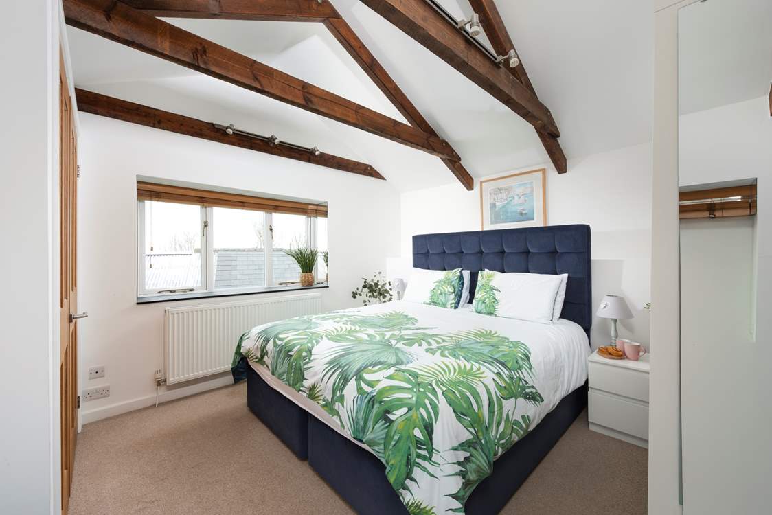 A room filled with natural light and views of the Cornish countryside.