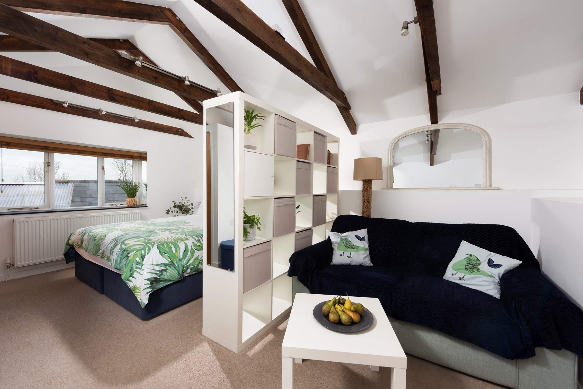 The door from the sitting and bedroom area opens onto three steps down to the shower-room and kitchen/dining-room.