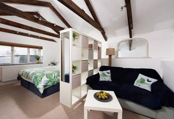 The door from the sitting and bedroom area opens onto three steps down to the shower-room and kitchen/dining-room.