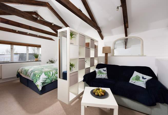 The door from the sitting and bedroom area opens onto three steps down to the shower-room and kitchen/dining-room.