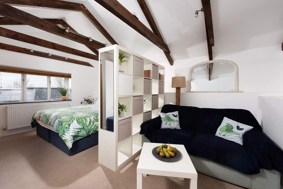 The door from the sitting and bedroom area opens onto three steps down to the shower-room and kitchen/dining-room.